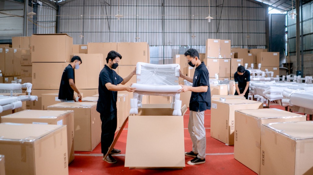 Workers packing a finished chair into export cartons, a typical furniture shipment for EUDR Malaysia exporters
